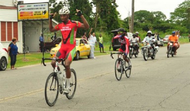 Roraima Bikers Club, Marlon ‘Fishy’ Williams celebrates as he crosses the finish line in yesterday’s 11th annual Victor Macedo road race. (Orlando Charles photo)