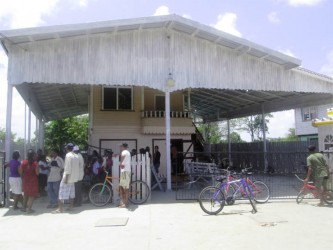 Residents offering sympathy at Deodat’s home yesterday 