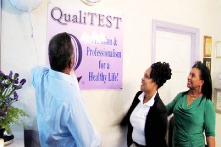 Prime Minister Samuel Hinds and his wife Yvonne Hinds unveil the plaque to the QualiTEST Lab with CEO Yvette Irving (GINA photo)
