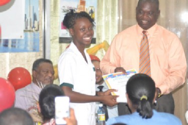 Postmaster General, Henry Dundas presenting an award to the top CSEC student of St. Rose’s High School (GINA photo) 