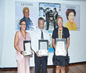 Prime Minister Samuel Hinds flanked by Cheryl Moore and Beverley Drake in whose honour commemorative stamps were launched  (Government Information Agency photo)