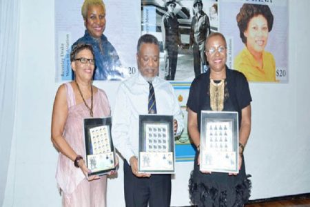 Prime Minister Samuel Hinds flanked by Cheryl Moore and Beverley Drake in whose honour commemorative stamps were launched  (Government Information Agency photo)