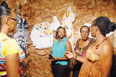 Talking fashion: Zarimah (right) showing off her creations while engaging visitors to her booth in a spell of fashion chat