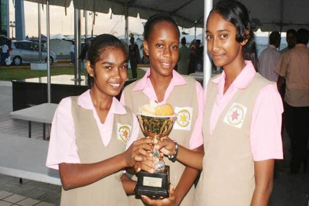 Triumphant teen chefs! (From left) Sunita Tomby, Olucho Haynes and Hannah Singh, from the New Amsterdam Multilateral Secondary School show off the first prize trophy for their winning steamed cassava and beef pies, which take pride of place inside the trophy. The schools’ cooking competition was judged yesterday the International Con-ference Centre and was one of the many events at the Caribbean Week of Agriculture. Thirty-four schools from across Guyana participated.
(Photo by Arian Browne)