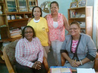 President of the GWMO Simona Broomes, seated at left, along with GWMO US member Sonja Fiedtkou-Perry and local member Dana Jones with Head of the Carnegie School of Economics Penelope Harris, seated at right, during initial talks on the training of women miners at the organization