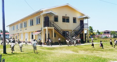 Students scampering to get  into the lines after hearing  the school bell