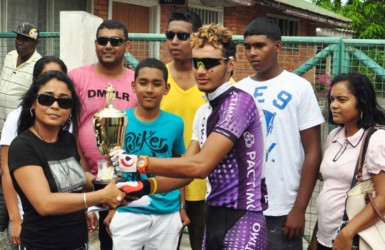 Paul DeNobrega receiving his winner’s trophy and an ounce of raw gold from Bibi Mohamed the daughter of the late Kadir Mohamed. (Orlando Charles photo) 