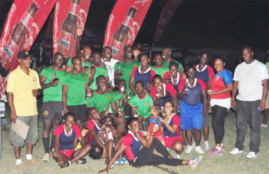 Winners of the Banks Sevens Championships GDF (male) and Hornets (female) pose with their hardware following yesterday’s tournament at the National Park Rugby field. (Orlando Charles photo)