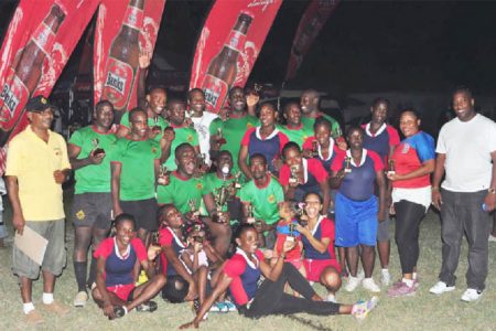 Winners of the Banks Sevens Championships GDF (male) and Hornets (female) pose with their hardware following yesterday’s tournament at the National Park Rugby field. (Orlando Charles photo)