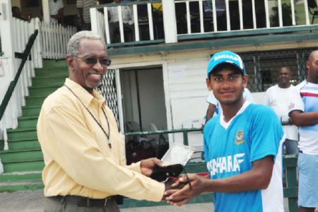 Man of the moment! Mehedy Miraj receives his man of the match award from Grantley Culbard. (Orlando Charles photo)
