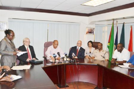 Minister of Home Affairs, Clement Rohee (third from left)  and Director of The Emergence Group, Dennis Hays (second from left) during the signing of the contract to establish the SWAT Unit. (GINA photo) 