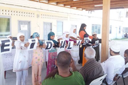 Children displaying an acrostic on Eid-ul-Adha
