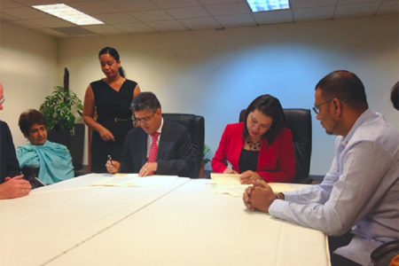 Minister of Foreign Affairs of Guyana Carolyn Rodrigues-Birkett (seated right) and Minister of External Affairs of Venezuela Elias Jaua Milano (seated left) in Port of Spain yesterday signing an agreement to explore mechanisms to address the issue of maritime delimitation within the context of international law. They agreed too that a technical team would meet in four months to exchange views on how that delimitation could proceed. Seated far right is Minister of Natural Resources and the Environment Robert Persaud. (Photo courtesy of Ministry of Foreign Affairs).
