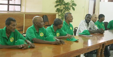 Head of the United Mini-bus Union Eon Andrews, fifth from left, speaking with bus operators about the importance of regularising bus services throughout the country.  (Arian Browne photo)  