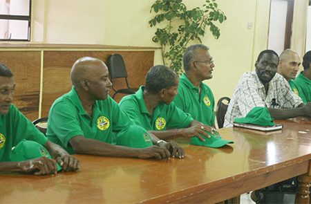 Head of the United Mini-bus Union Eon Andrews, fifth from left, speaking with bus operators about the importance of regularising bus services throughout the country.  (Arian Browne photo)
