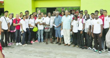 Director of Sport, Neil Kumar (with spectacles at centre) along with Guyana’s delegation of athletes and officials pose for a Stabroek Sport photo after arriving at the Stardust Hotel here in Paramaribo, Suriname. (Orlando Charles photo) 