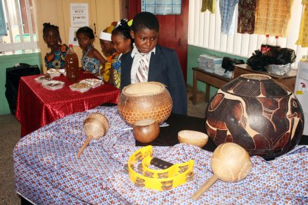 This young man was staring intently at a display of African musical instruments at the Stella Maris culture day. 