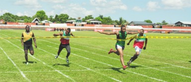 Guyana’s sprint ace, Kevin Abensettes celebrates after claiming a narrow victory ahead of Suriname’s Risingi Resida in the men’s 100m yesterday at the Andre Kamperveen Stadium here in Suriname. (Orlando Charles photo) 