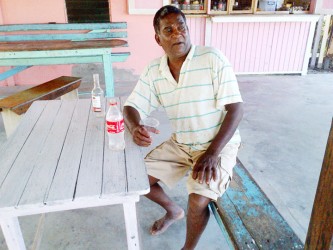 A villager having what he called “an afternoon toops” at his friend’s shop 