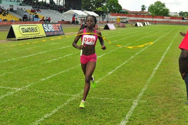 All Alone! Jevina Sampson anchoring Guyana’s 4x400m relay team to victory without a Surinamese in sight. (Orlando Charles photo) 