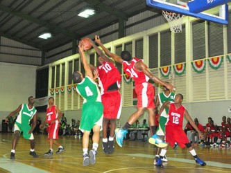 Action during the Suriname/Guyana male basketball game Saturday. (Orlando Charles photo) 