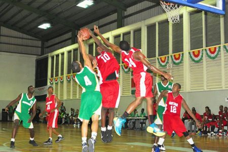 Action during the Suriname/Guyana male basketball game Saturday. (Orlando Charles photo)
