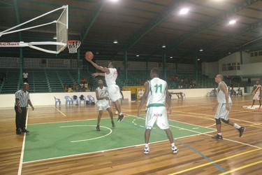 Shelroy Thomas (No.15) going up for a layup while Jahmal Henar (No.11) of Yellowbirds looks on.