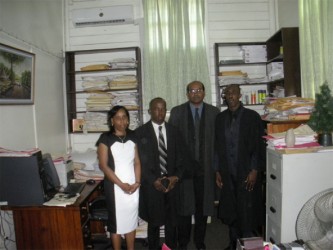 In this Zoisa Fraser photo Jervis poses with from left to right, his mother Say Jervis, attorney Lester Caesar and Justice Rishi Persaud moments after he was accepted to the local Bar