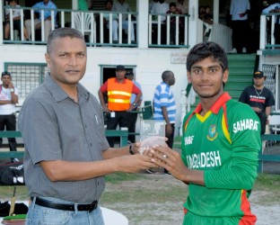 WICB director Anand Senasie presents Mehedy Hasan with the winner’s trophy. (Photo courtesy of West Indies Cricket photostream) 