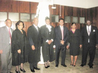Naomi Christie is flanked by, from left, Agriculture Minister Dr Leslie Ramsammy, Solicitor Evelyn Sita Ramlal and Justice Brassington Reynolds, and from right, Rockcliff and Pearl Christie and Attorney General Anil Nandlall.  