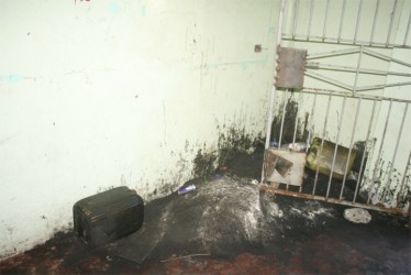 The entrance of the building blackened with tar and waste oil, while a corner of the entrance has become a miniature dumpsite. 