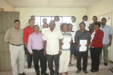 Minister in the Ministry of Local Government and Regional Development Ganga Persaud, Permanent Secretary Collin Croal, Regional Chairman Wilson Lorentio and Regional Executive Officer Claire Singh with representatives of the 11 Amerindian communities that collected funds for the upgrade to their sport grounds (Government Information Agency photo) 