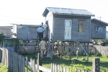 Police officers enter the cottage where Maharani Parmanand’s body was found.  