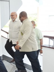 President Donald Ramotar being escorted into the Convention Centre for the launch of the project by Small Business Bureau Chief Executive Officer Derrick Cummings