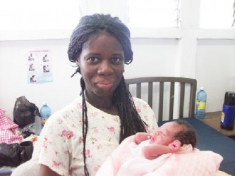 Coretta Shape holds her newborn baby boy 