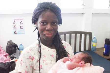 Coretta Shape holds her newborn baby boy
