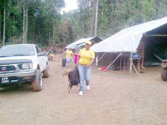 President of the GWMO and other members are seen removing the bags of victims of trafficking in persons from an interior location.