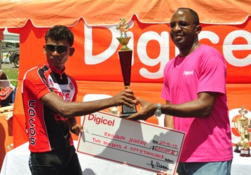 Raynauth Jeffrey receiving his spoils from Digicel’s CEO, Gregory Dean. (Orlando Charles photo)