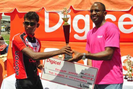 Raynauth Jeffrey receiving his spoils from Digicel’s CEO, Gregory Dean. (Orlando Charles photo)