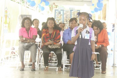 Former East Street Nursery student Chadency Christmas performing her calypso, “The Golden Key” at the commissioning of the rebuilt school yesterday  