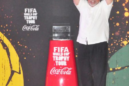 President Donald Ramotar holds the FIFA World Cup Trophy aloft. (Orlando Charles photo)
