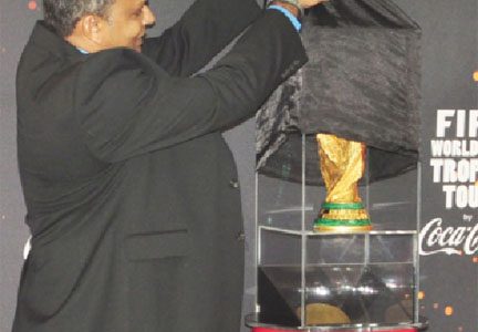 Minister of Culture, Youth and Sport Dr. Frank Anthony unveiling the International Federation of Association Football (FIFA) World Cup Trophy for the first time in Guyana. (Orlando Charles photo)