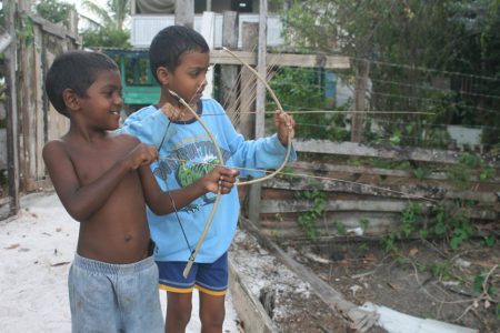 Boys playing with makeshift bows and arrows at Felicity, East Coast Demerara yesterday.