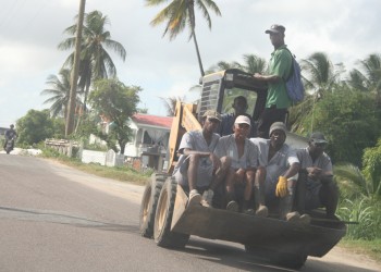 Prisoners being transported yesterday on this front end loader to a location in Lusignan.