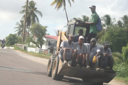 Prisoners being transported yesterday on this front end loader to a location in Lusignan.