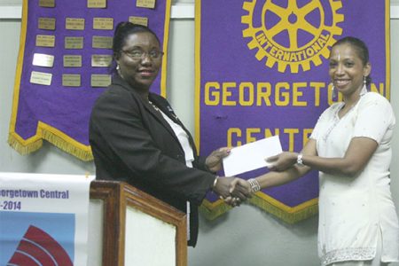 Georgetown Central Rotary Club President Judy Semple-Joseph (left) receives the cheque from Courts representative Molly Hassan.
