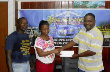 GFA Treasurer Dexter Schultz (right) collecting the sponsorship cheque from Star Party Rental Office Manager Pheona Jones while company Supervisor Floyd Spencer look on 