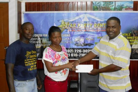 GFA Treasurer Dexter Schultz (right) collecting the sponsorship cheque from Star Party Rental Office Manager Pheona Jones while company Supervisor Floyd Spencer look on
