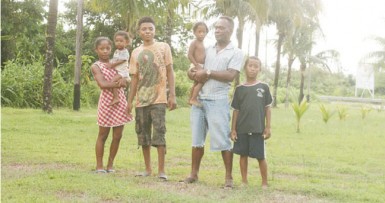 Michael Marks and his family on his front lawn, which he landscaped himself.