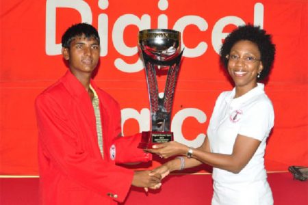 Avinda Kishore receives his trophy from Digicel’s Head of Marketing Jacqueline James. (Orlando Charles photo)
